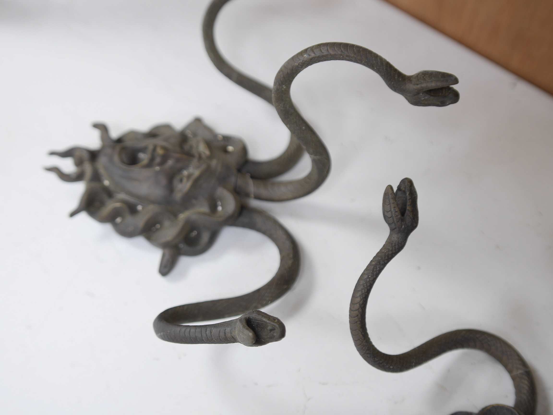 A pair of bronze ‘Medusa’ three branch wall plaques, 33cm high. Condition - good